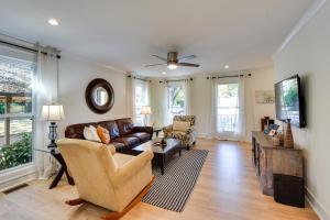 a living room with a couch and a tv at Tranquil Travelers Rest Home with Fire Pit! in Travelers Rest