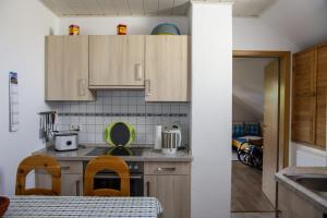 a kitchen with wooden cabinets and a table with chairs at Ferienwohnung Schwudke Wohnung 63 in Gartow