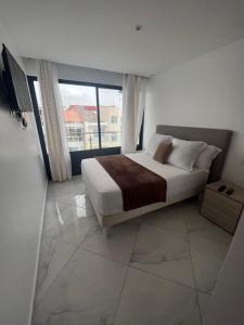 Postel nebo postele na pokoji v ubytování Residencial Santo Amaro