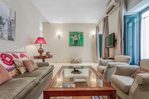 a living room with a couch and a coffee table at FAM Sevillian Townhouse in Seville