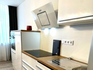 a small kitchen with a sink and a microwave at BeeFree WhirlpoolSuiteXL33-FreeParking-FastWiFi in Passau