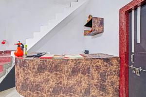a room with a wooden counter with a staircase at Hotel O Sai Anant in Bilāspur