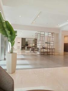 a large lobby with a potted plant in the middle at Cebu 1 bed Luxury Condo with high speed Internet in Cebu City