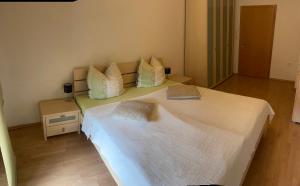 um quarto com uma grande cama branca com almofadas em Ferienwohnung am Schloss 
