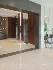an empty lobby with wooden doors and a table at Cebu 1 bed Luxury Condo with high speed Internet in Cebu City