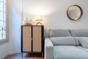 a living room with a couch and a mirror at New premium flat - Malaga Center in Málaga