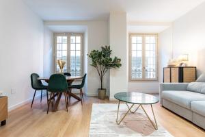 a living room with a table and a couch at New premium flat - Malaga Center in Málaga
