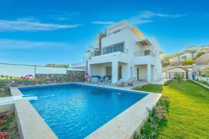 a villa with a swimming pool in front of a house at unique villa with heated pool and Spa in Hurghada