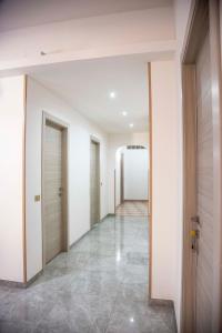 an empty hallway with white walls and tile floors at Blu Mare Lampedusa Bed And Breakfast in Lampedusa
