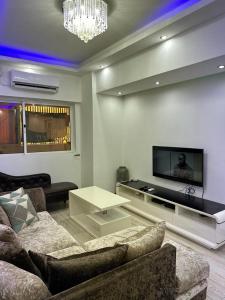 a living room with a couch and a tv at Lovely house in Luanda Centre with treadmill in Luanda