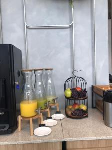 two bottles of orange juice and a tray of fruit at Brava Mundo Hotel Boutique OFICIAL in Itajaí
