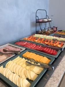 a buffet with many different types of cheese and vegetables at Brava Mundo Hotel Boutique OFICIAL in Itajaí