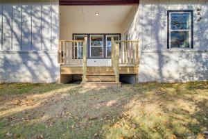 a porch of a house with a door and stairs at Charming Grove Home with Deck Near Grand Lake! in Grove