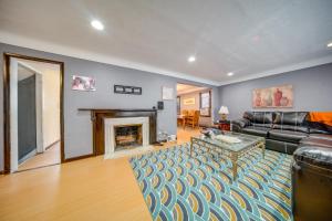 a living room with a couch and a fireplace at University Heights Home Near Downtown Cleveland! 