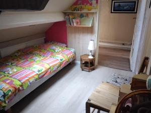 a bedroom with a bed and a table and a chair at Appartement centre ville classé unesco in Le Havre