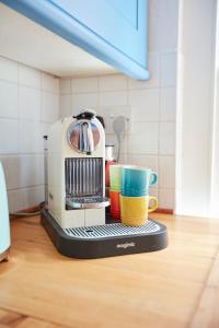 a coffee maker with two cups on a counter at The Boat House in Aldeburgh