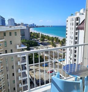 a balcony with a table and a view of the beach at KASA Seaview at Coral Beach - Studio for 2 Balcony BEACHFRONT BUILDING POOL in San Juan