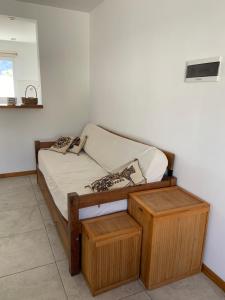 a bedroom with a wooden bed with two wooden tables at Departamento Mirta in Esquel