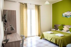 a green bedroom with a bed and a window at Blu Mare Lampedusa Bed And Breakfast in Lampedusa