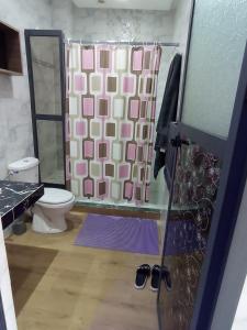 a bathroom with a shower with a toilet and a glass door at Appartement luxueux à louer à Taounate in Taounate