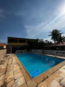 a swimming pool in front of a house at Casa em Saquarema in Saquarema