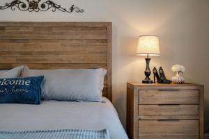 a bedroom with a bed with a wooden headboard and a lamp at Serhii Villa Orlando - Heated Pool, Spa, Game Room - close to Disney in Davenport