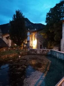 a villa with a swimming pool at night at Cjase di Doro in Illegio