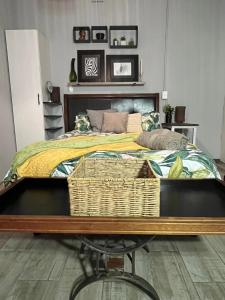 a bedroom with a large bed with a basket on it at Kiewiets Creek Guesthouse in Pretoria