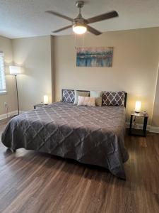 a bedroom with a large bed with a ceiling fan at Spacious 2 Bed, 2 Bath Uptown Gem in the Heart of the City-Parking-Wi-Fi-Balcony-Walk to BOA Stadium in Charlotte