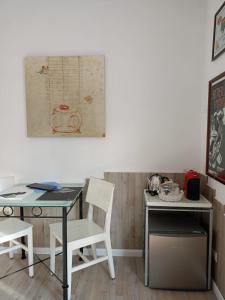 a desk and a table with a chair next to a desk at B&B VALCHISONE in Pinasca 