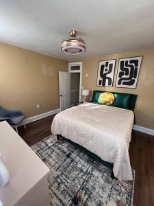 a bedroom with a large bed and a rug at Cozy on the Hill in Wilmington