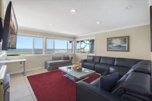 a living room with a couch and a table at Santa Cruz Ocean Front in Santa Cruz