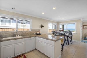 a kitchen and dining room with a table and chairs at Santa Cruz Ocean Front in Santa Cruz