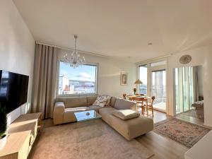 a living room with a couch and a table at Hostit Arctic Apartments in Rovaniemi