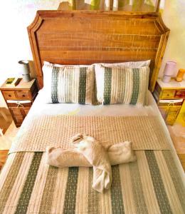 a cat made out of towels laying on a bed at Cozy Modern Upstairs 2 Bed A/C Apt Near 2 Everything in Saint Philip