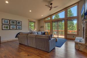a living room with a couch and a fireplace at Spruce Haven by Tahoe Getaways at Tahoe Donner - Luxury Pet Friendly Cabin w Private Hot Tub in Truckee