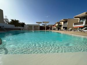 a large swimming pool with blue water in a building at Las Piteras in Playa de las Americas