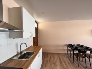 a kitchen with a sink and a table at Las Piteras in Playa de las Americas