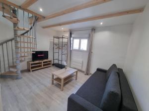 a living room with a couch and a table at Le Rawai in Fos-sur-Mer