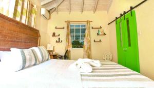 a bedroom with a bed with towels on it at Cozy Modern Upstairs 2 Bed A/C Apt Near 2 Everything in Saint Philip