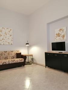 a living room with a couch and a flat screen tv at Don Onofrio in Monopoli