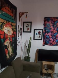 a living room with a couch and a television at Hostel Resende in Resende