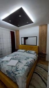 a bedroom with a large bed with at Apartman Luna in Valjevo