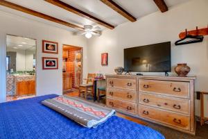 a bedroom with a tv and a blue bed at Santa Fe Motel & Inn in Santa Fe