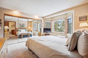 a bedroom with a large bed and a television at Atrium 106 in Breckenridge