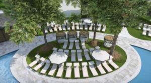 an overhead view of a picnic table and chairs next to a pool at The Ritz-Carlton Dallas, Las Colinas in Irving
