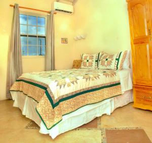 a bedroom with a bed and a window at Cozy Modern Upstairs 2 Bed A/C Apt Near 2 Everything in Saint Philip