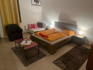 a living room with a bed and a couch at Monelly Apartman in Komárno