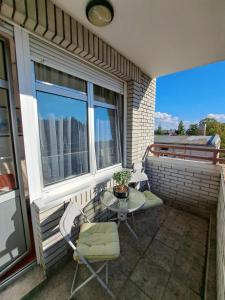 a patio with a table and chairs on a balcony at Ramonda in Belgrade