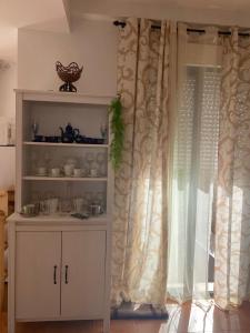 un armario blanco en una cocina junto a una ventana en Casa rural Cañaveral de León, en Cañaveral de León